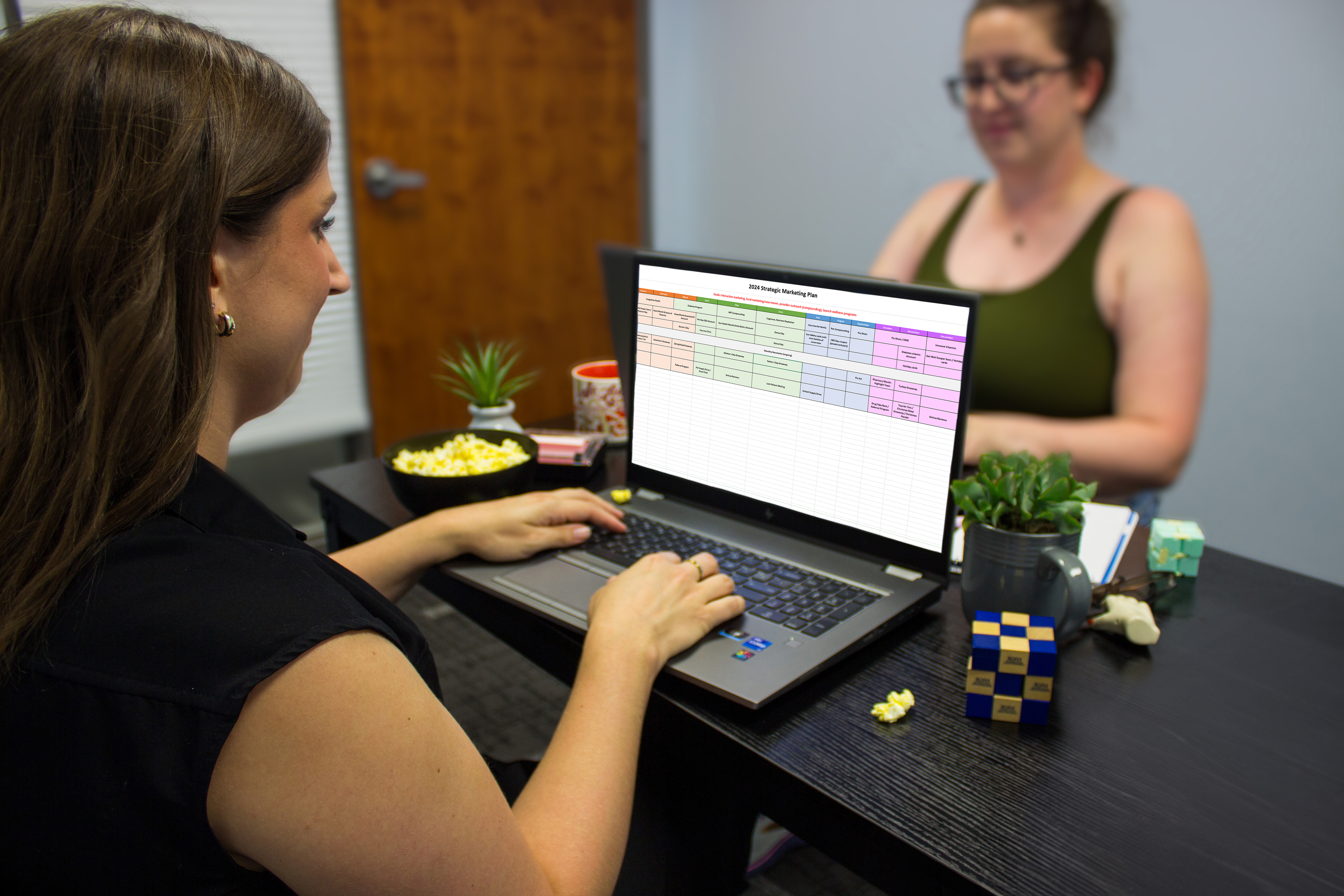 two women working on strategic marketing plan