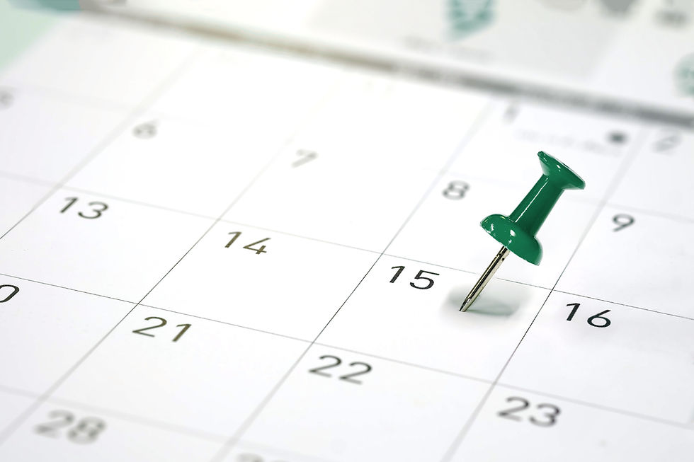 green push pin on a calendar date