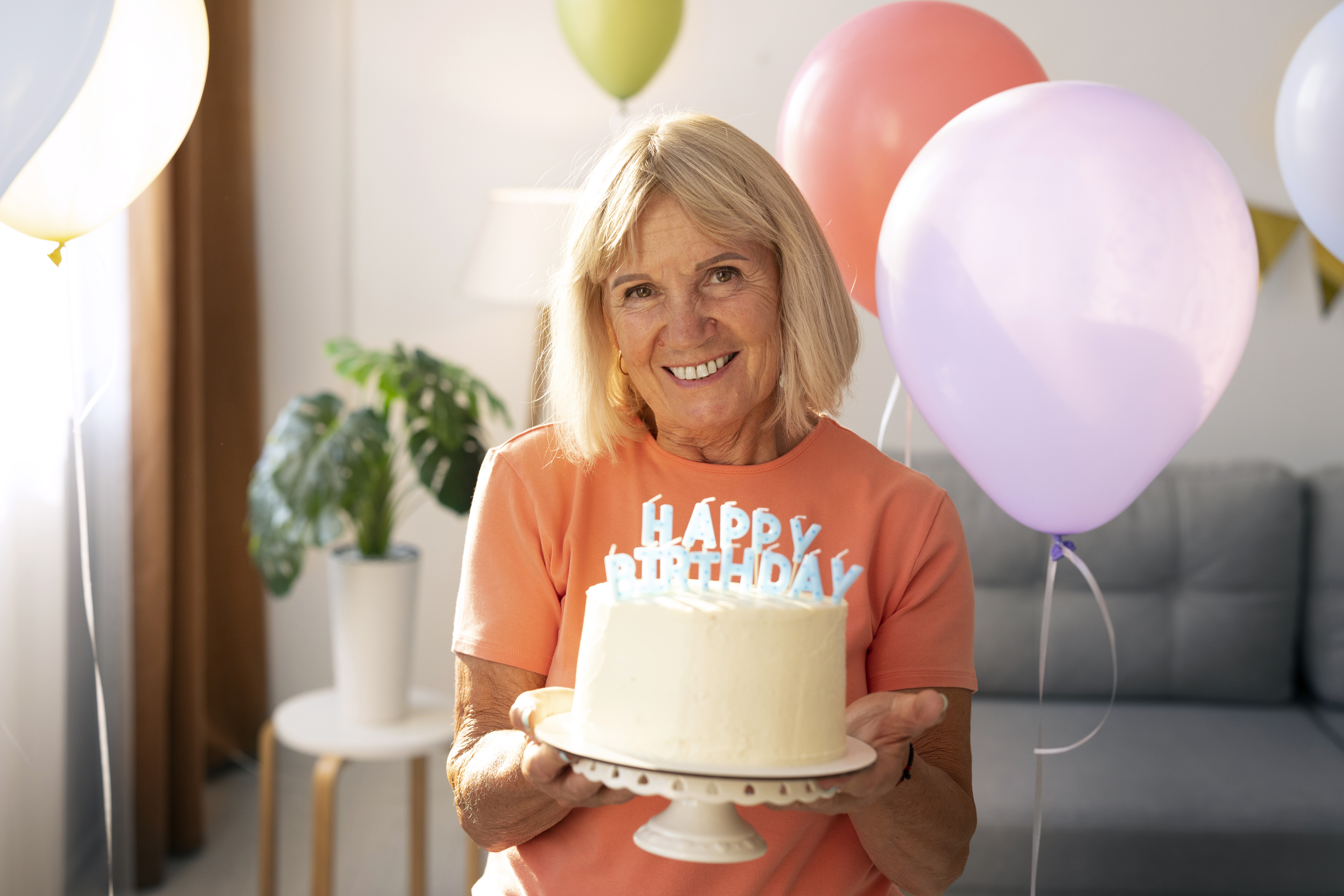 senior woman hold birthday cake