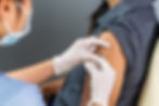 Pharmacist administering vaccine