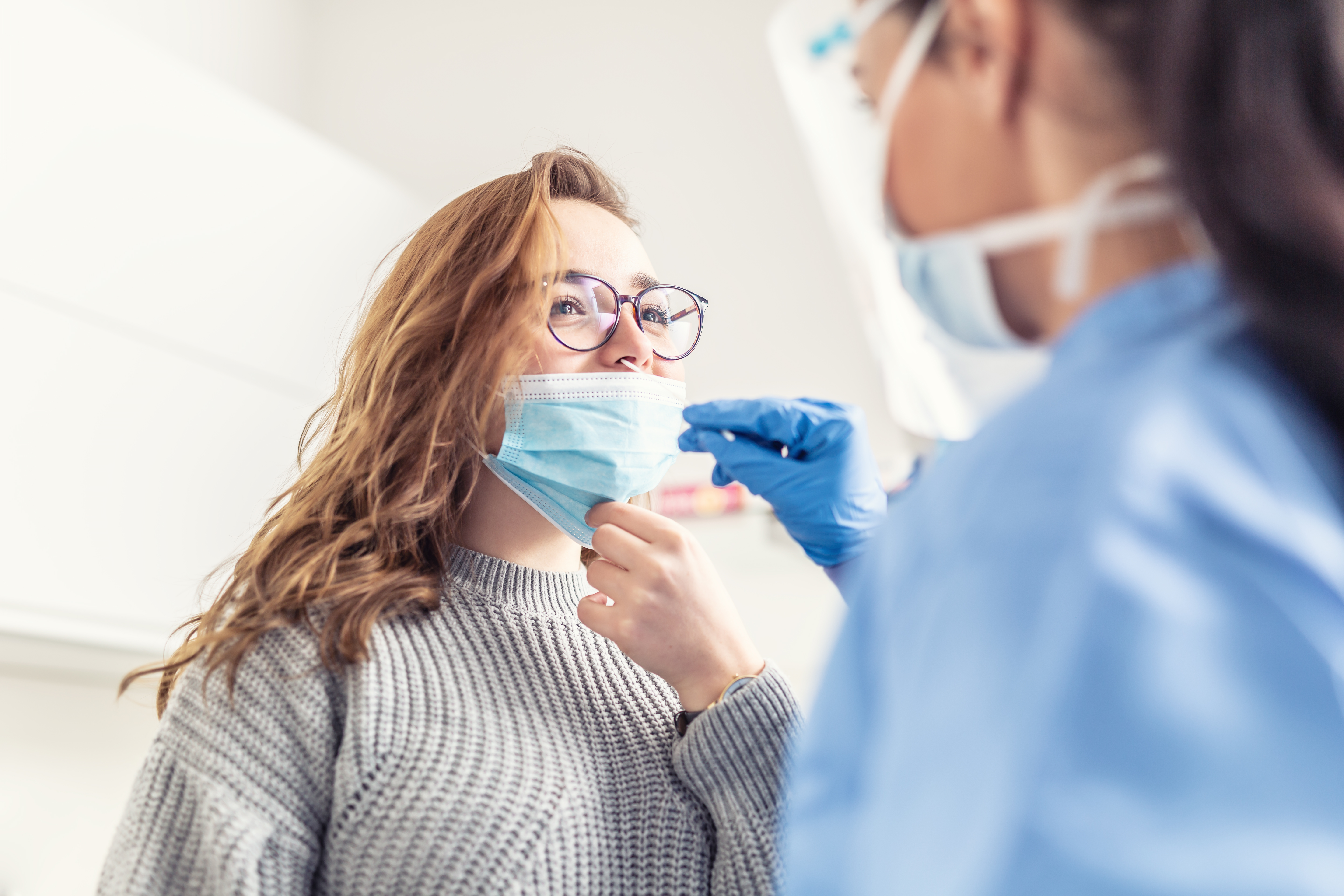 woman_administering covid test_mask_gloves_point of care testing_nose.jpg