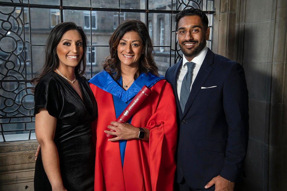 Naeema, wearing red graduation robes, with her son and daughter at her sides, accepted her honorary degree from the University of Edinburgh.