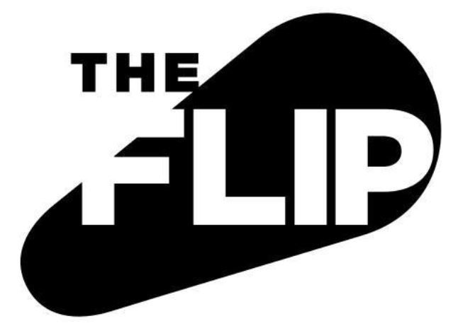 Close-up view of a vintage pinball machine with detailed artwork and flashing lights