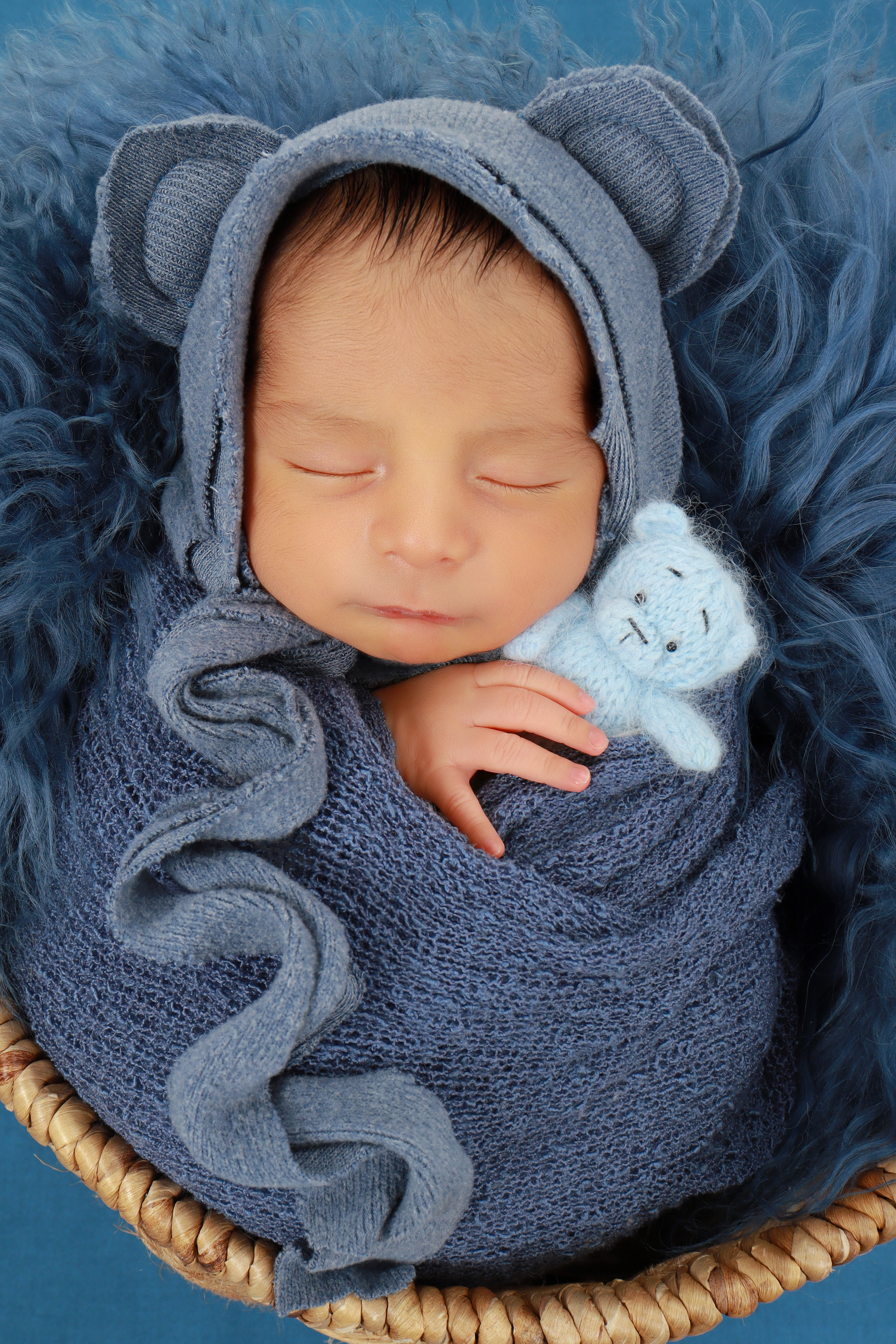 Newborn portrait in a blue wrap