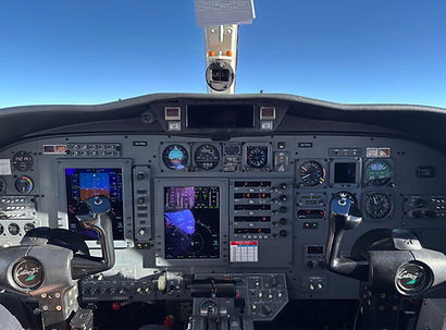 Photo of a private jet cockpit while in the sky