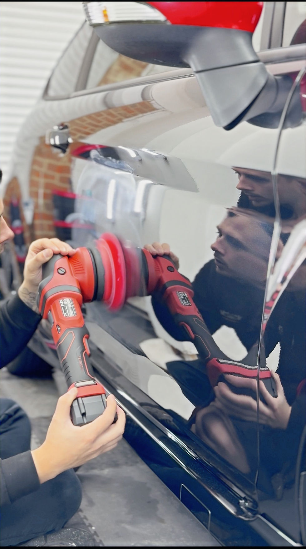 Close up of a person machine polishing a car