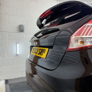 Black car rear view with license plate detail, Platform Auto Detailing