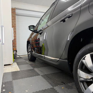 Gray SUV in garage. Chrome trim, tires, and doors, Platform Auto Detailing
