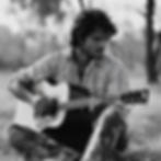 Man playing guitar in Australian landscape