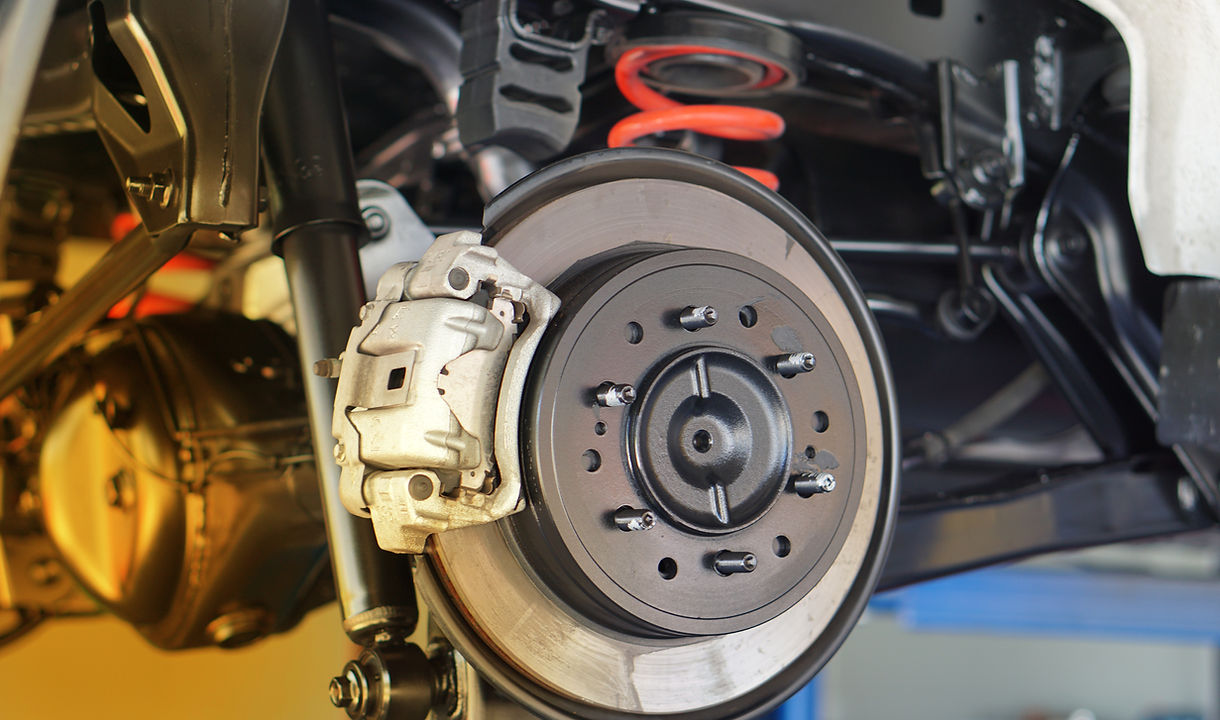 Disc brake of the vehicle for repair, in process of new tire replacement. Car brake repair