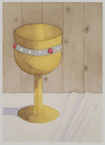 A gem studded golden goblet sits upon a table covered with a white cloth.
