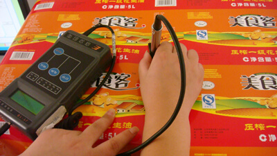 Operator verifying tonal balance and color stability on printed sheets.