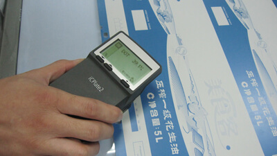 Close-up of offset sheet inspection to maintain consistent color across the run.