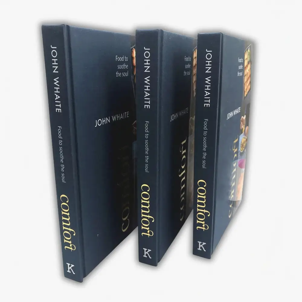 Open catalog with a photograph extending across facing pages and the center gutter visible