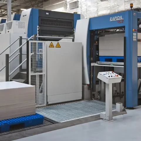 Heidelberg press operator adjusting print settings on touchscreen control panel