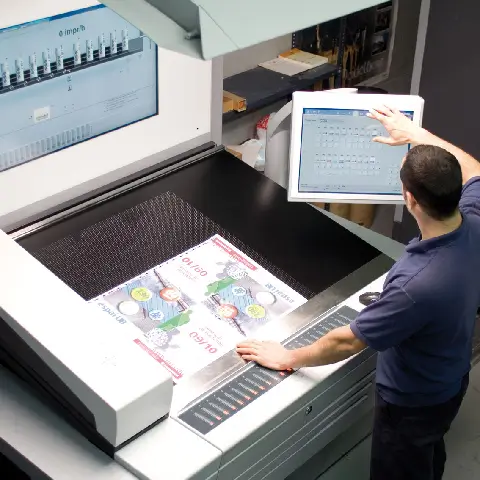 Close-up of Heidelberg offset press rollers and ink fountains in operation