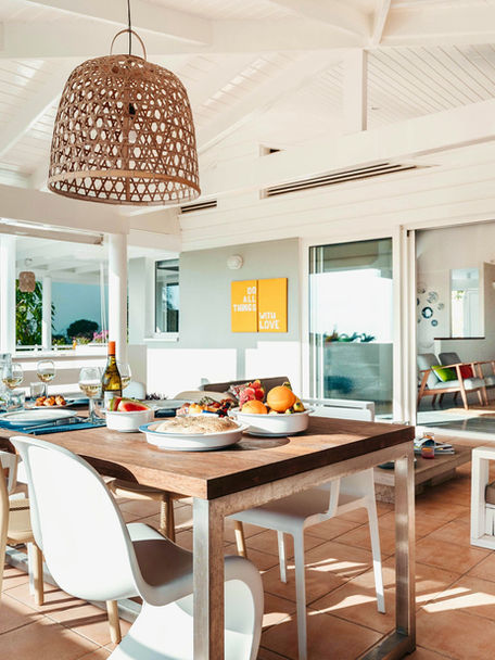 Porch with large dining table and lounge area.