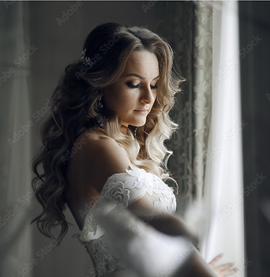 Bride preparing beside window light before wedding ceremony