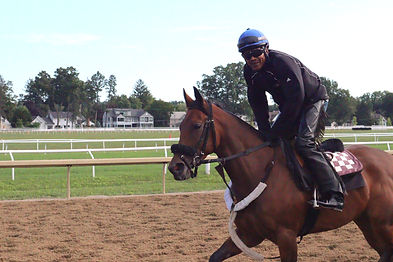 Backstretch workers caring for horses in a stable, showcasing the dedication and teamwork of the Backstretch Employee Service Team in providing support and services to the racing community.