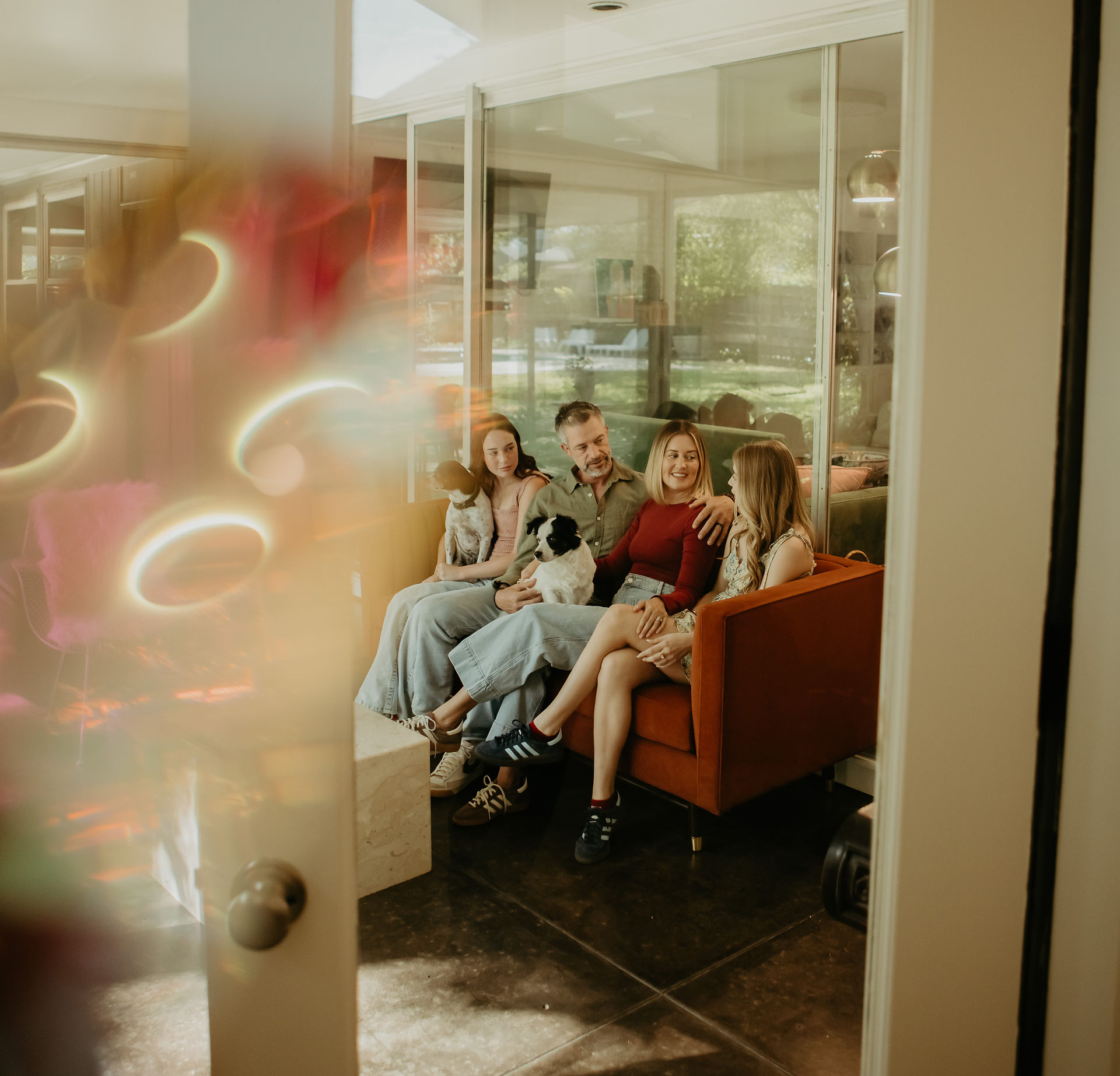 king family sitting on couch in sunroom
