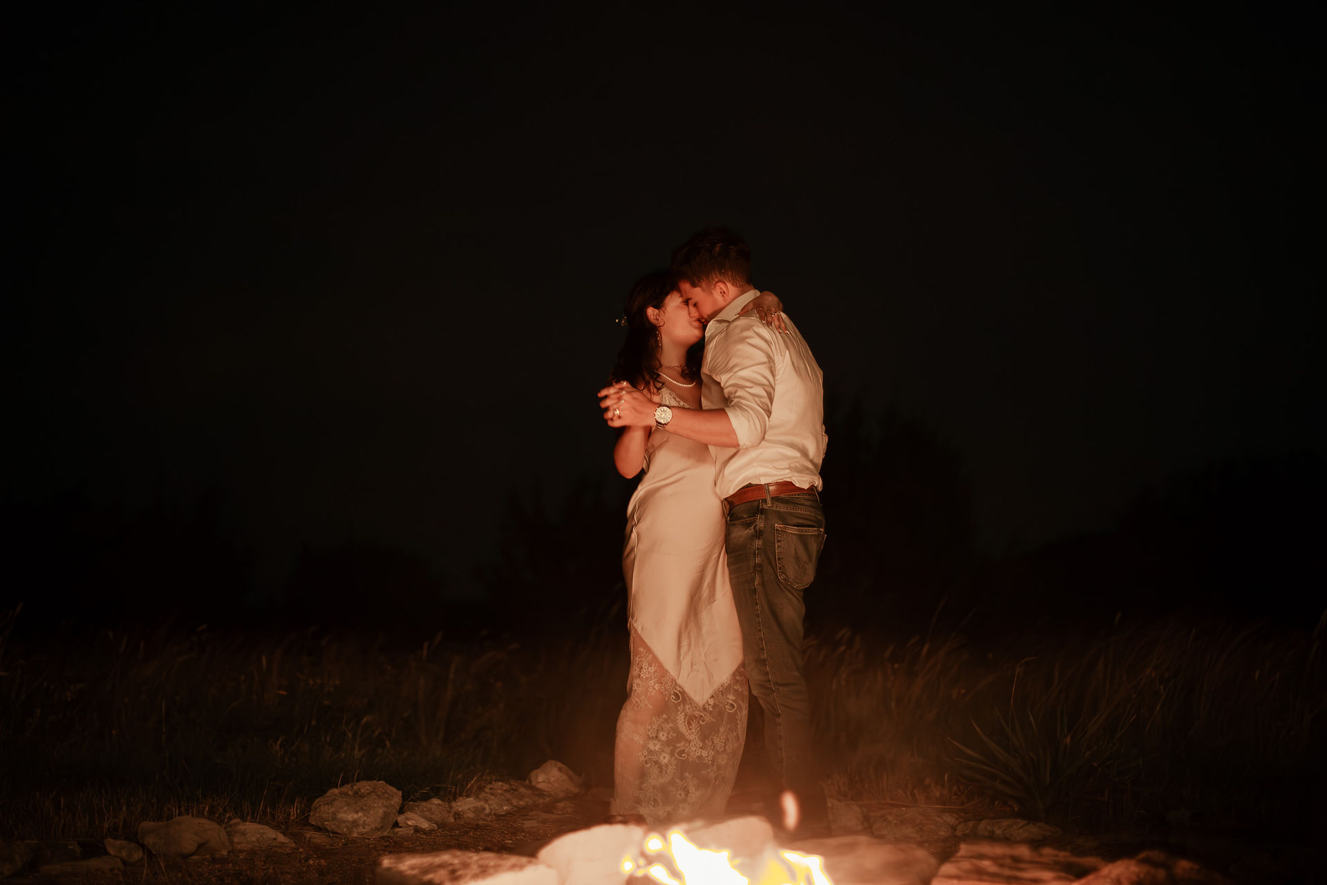 first dance in the firelight at night time