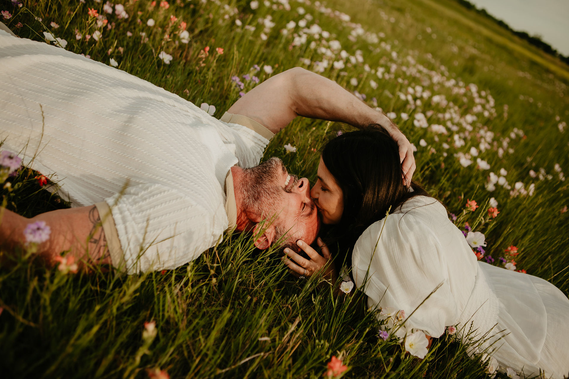 couple laying in grass 