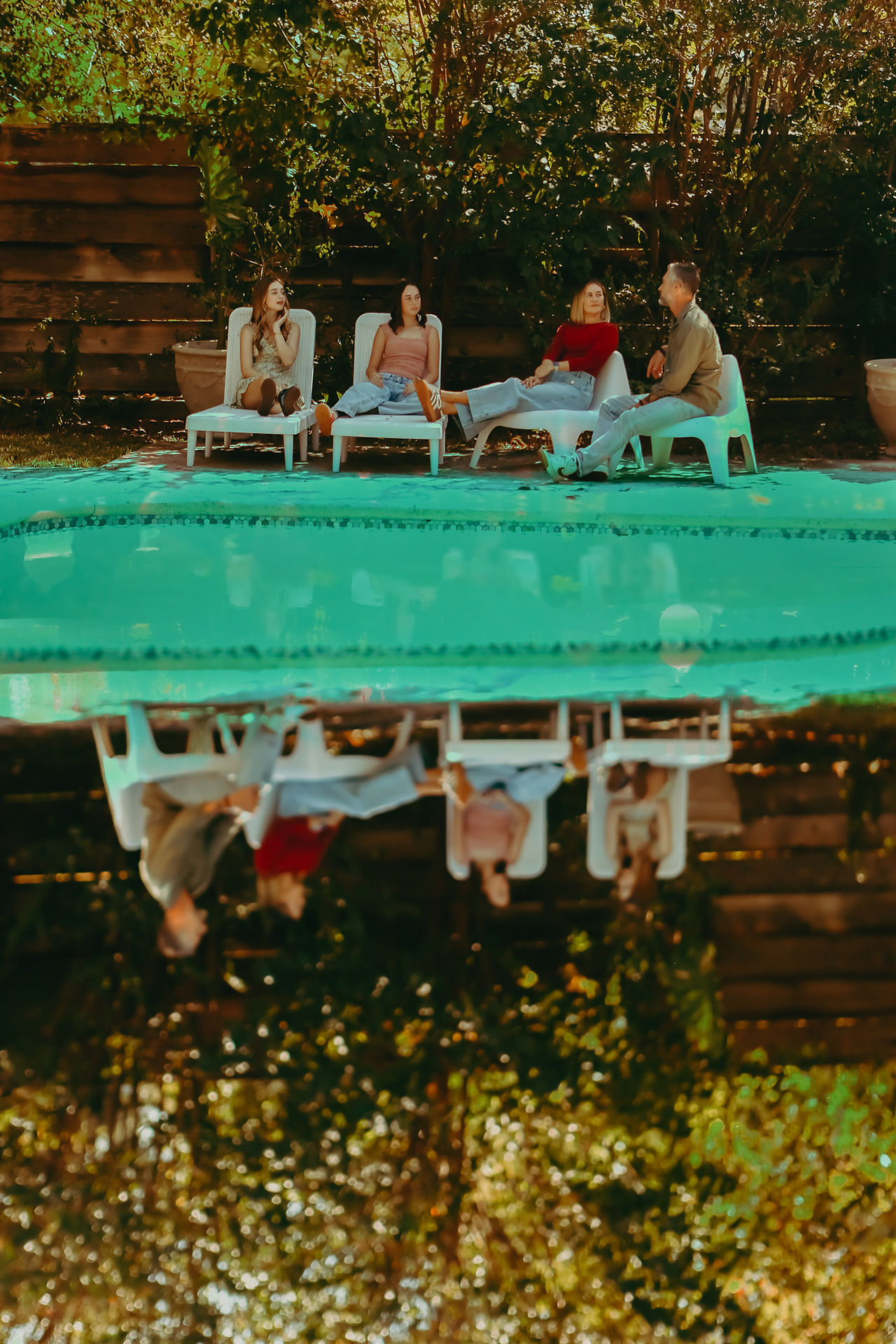 double exposure photograph of king family standing by pool