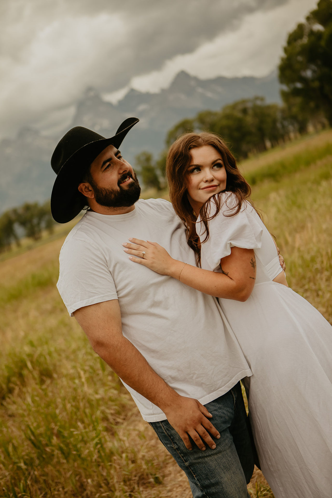 Romantic moment under glowing skies in Grand Teton National Park after proposal