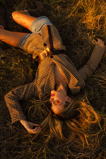 girl laying in grass during editorial photoshoot