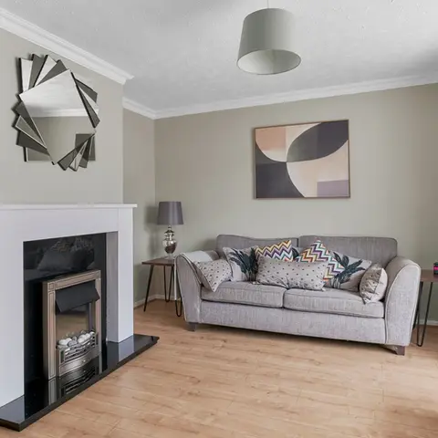Property Photography North East is a folio of North Star Images
Specialising in Serviced accommodation photography, Interior Photography HMO Photography Stockton on tees
A modern HMO living room with a gray sofa, abstract wall art, a round mirror above a fireplace, light wood flooring, and side tables with lamps and books featuring a tranquil green colour palette. This marketing image was photographed by Property Photography North East a folio of North Star Images.
