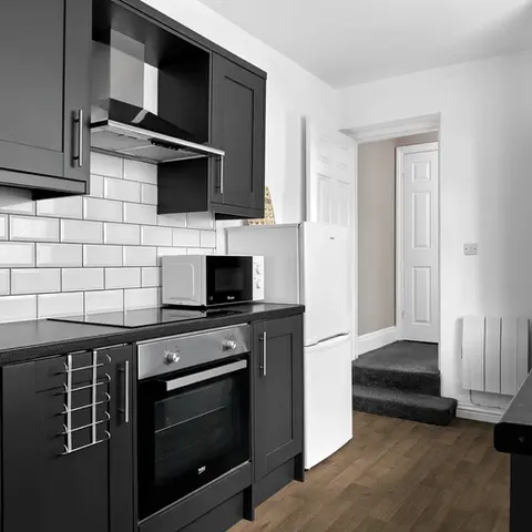 Property Photography North East is a folio of North Star Images
Specialising in Serviced accommodation photography, kitchen Photography HMO Photography and student accommodation photography Washington.
Modern serviced accommodation kitchen with dark cabinets, white subway tile backsplash, stainless steel appliances, and wooden floor. Bright, clean, and minimalist. This was photographed for marketing material and online listings by property Photography North East a folio of North Star Images.