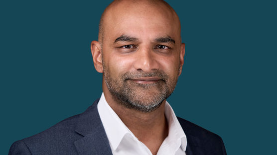 Professional headshot of a business man wearing a suit. A bright, confident and approachable portrait, perfect for personal branding, LinkedIn, and social media. Photo by North Star Images.