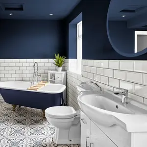 Property Photography North East is a folio of North Star Images
Specialising in Serviced accommodation photography, bathroom Photography HMO Photography Newcastle
A modern bathroom featuring a freestanding bathtub, a white vanity with a sink, a toilet, and decorative tile flooring. The walls are painted dark blue with white subway tiles. Natural light enters from a window, and a small plant is placed on the vanity. This shows that a modern serviced accommodation bathroom photographed by property Photography North East a folio of North Star Images