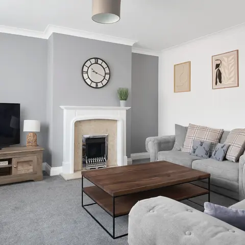 Property Photography North East is a folio of North Star Images
Specialising in Serviced accommodation photography, Interior Photographer HMO Photography South Shields
Modern serviced accommodation living room with grey sofa and armchair, wooden coffee table, flat screen TV on wooden media unit, decorative fireplace with mantel clock, neutral grey walls, framed minimalist artwork, and soft carpet creating a bright, comfortable rental property interior.
This HMO or service accommodation marketing image was photographed by Property Photography North East a folio of North Star Images.