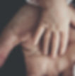 Symbolic image of a baby's hand in their parents to show family bonds and decisions around a child's surname in Ontario Family Law.