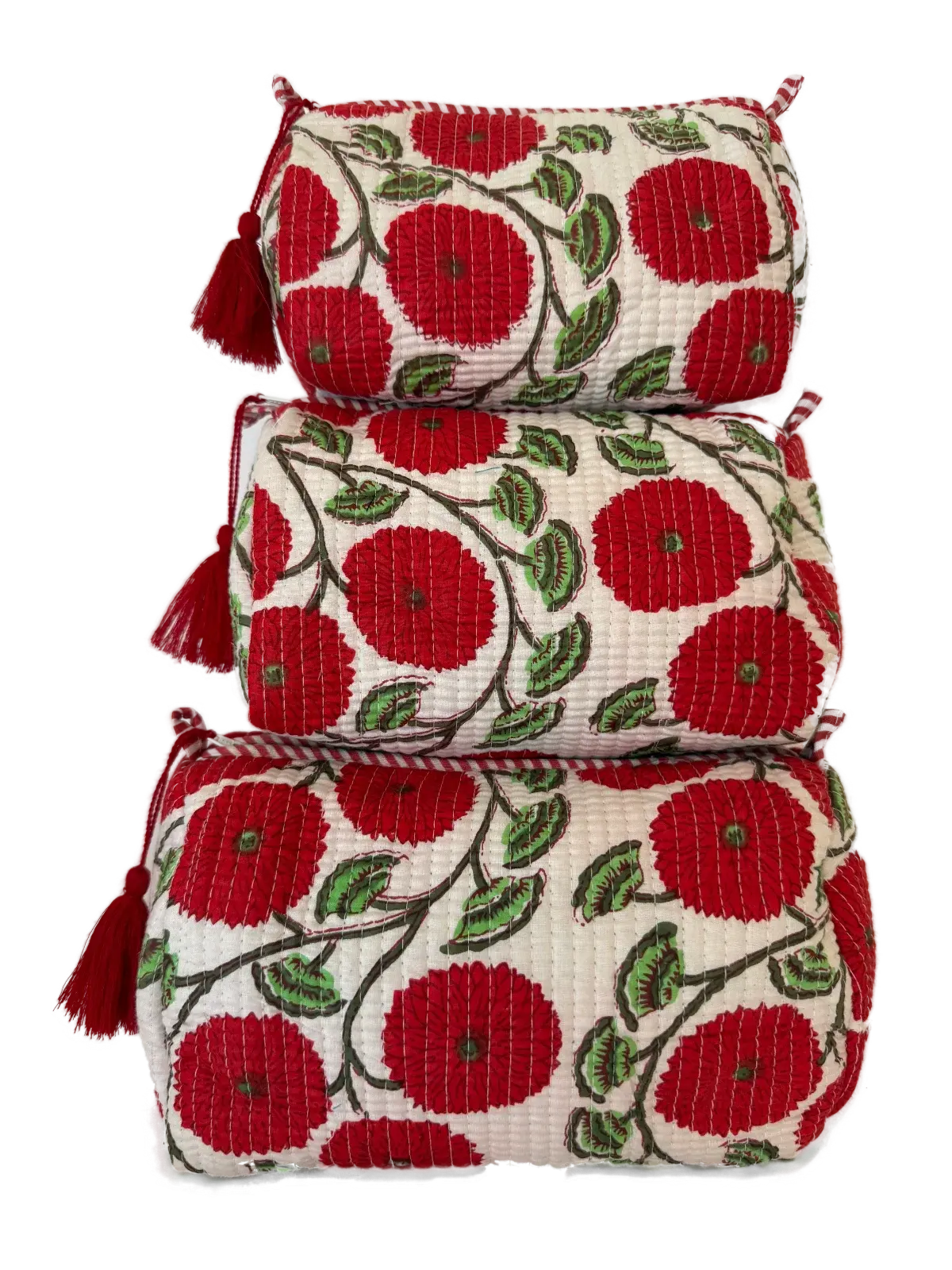 a quilted cotton pouch set with bold red floral motifs on a soft ivory background.