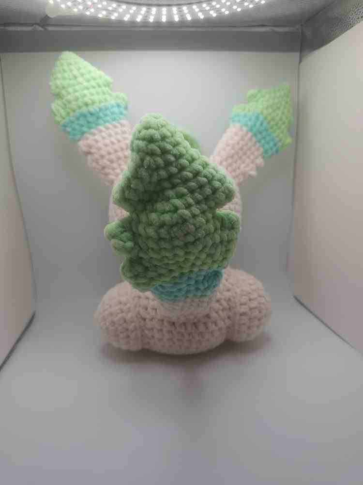 Amigurumi evolving companion plushie in a lightbox