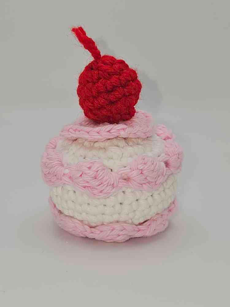 Amigurumi crochet mini cake in white and pink with cherry