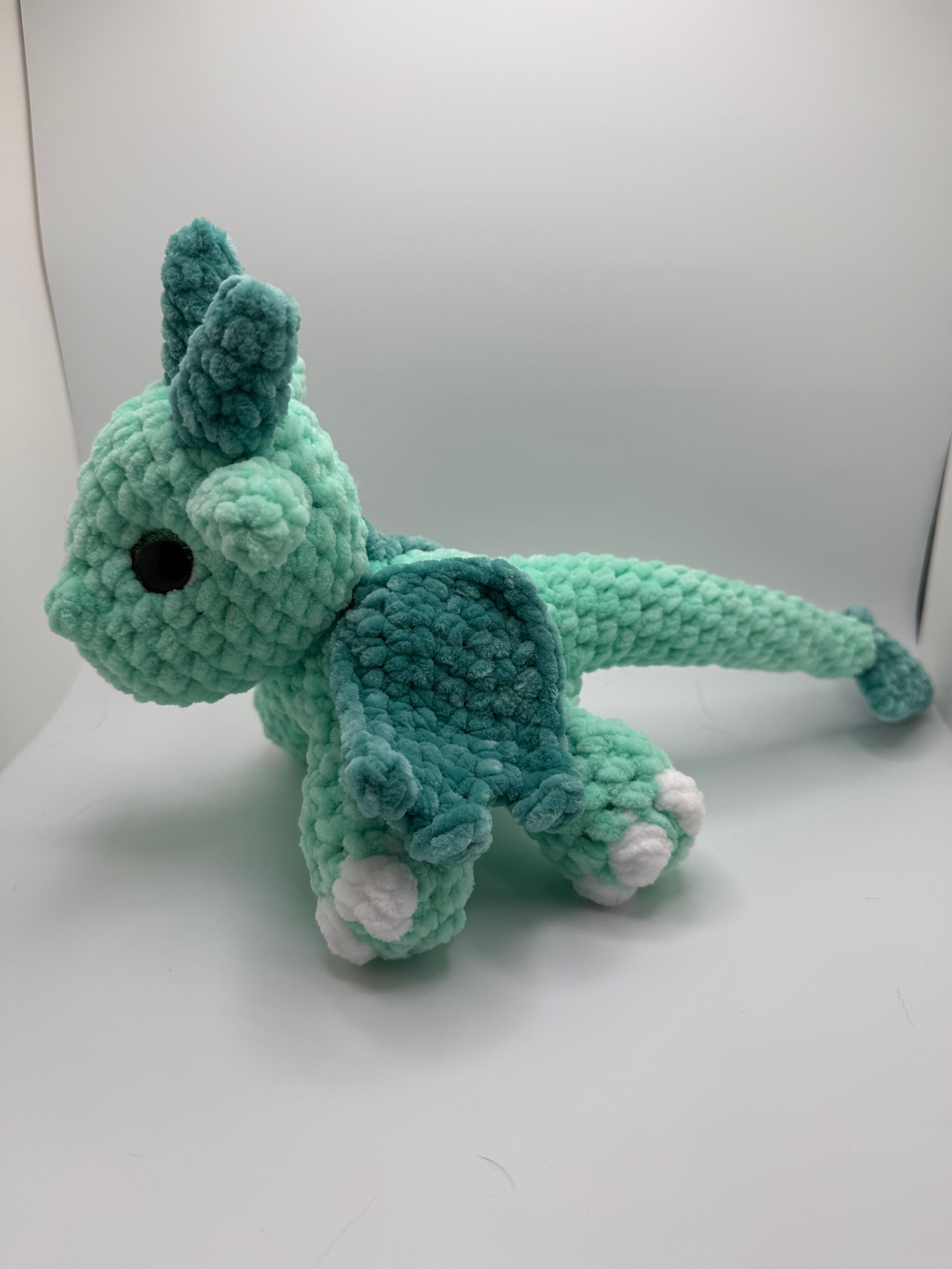 Small green Amigurumi Dragon Hatchling with teal wings