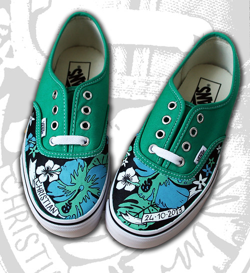 Vans decorated with a hand-painted floral customization on the toes