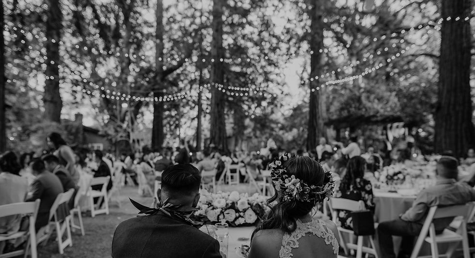 filipino couple looks out at their guests during their wedding reception at deer park villa