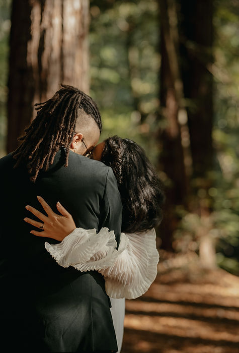 newlywed couple share an intimate moment after their ceremony in the redwoods in berkeley