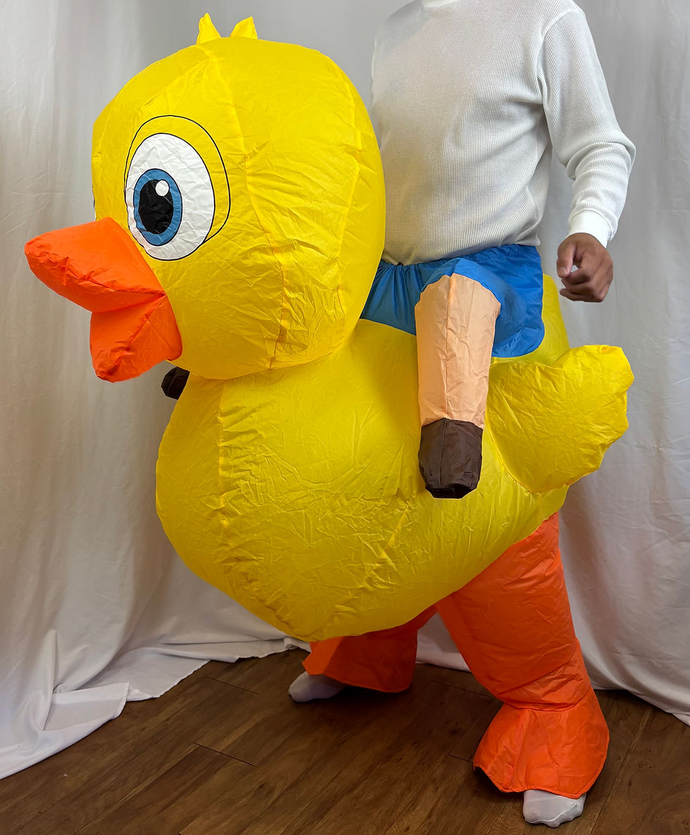 Adult wearing an inflated yellow cartoon ride-on duck costume for a party.