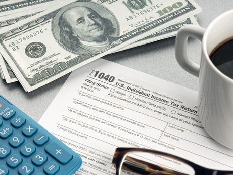 tax refund with money, a calculator and coffee