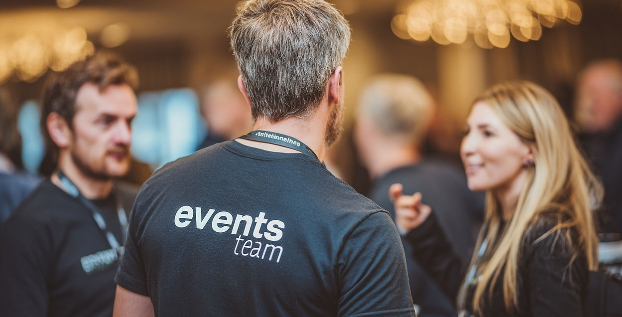 Event directional staff in Las Vegas guiding conference attendees during badge verification and check-in. Trained event staff wearing branded ‘events team’ shirts assist guests with navigation, prevent bottlenecks at registration desks, and ensure smooth guest flow. Professional Las Vegas directional staff help maintain order, improve guest satisfaction, and keep large conferences on schedule with efficient wayfinding support.