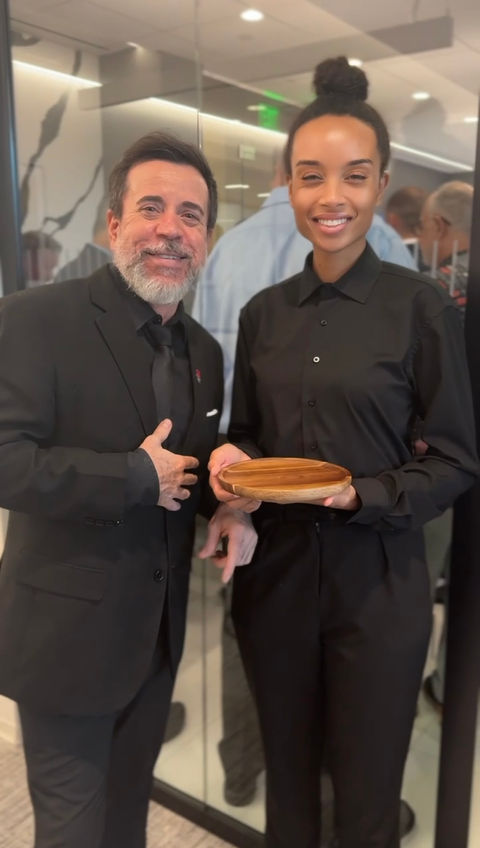 Professional hospitality server assisting a guest during a corporate event in Las Vegas. Guest-facing food and beverage staff providing attentive service, event support, and hospitality assistance for networking receptions, executive gatherings, convention functions, and private celebrations.