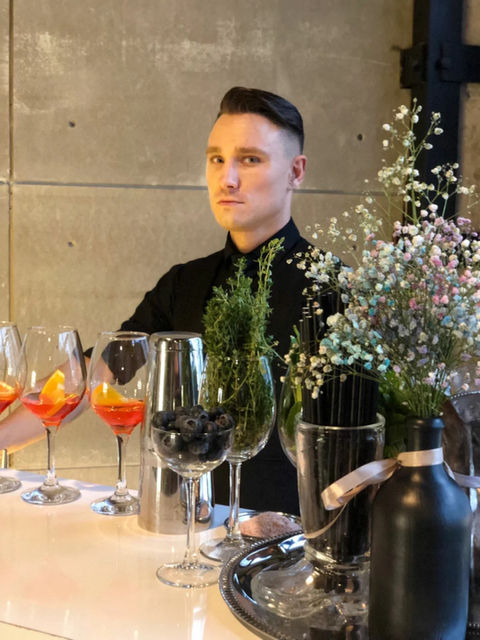Polished bartender supporting a Las Vegas fashion event with premium beverage service. Hospitality specialist preparing cocktails and guest refreshments for brand showcases, luxury networking receptions, designer presentations, and VIP experiential events.