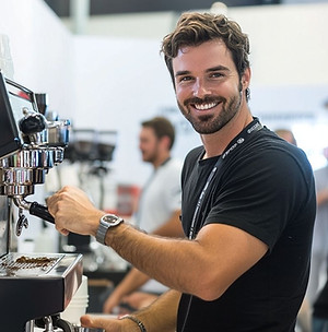 Hospitality bartender and catering staff member preparing coffee service during a San Francisco corporate event, supporting guest hospitality and beverage service for Bay Area conferences and networking events.
