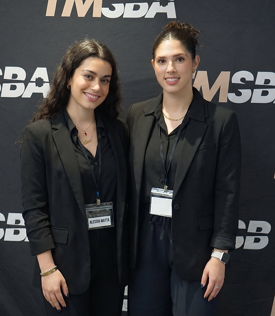 Two convention support professionals in coordinated business attire assisting exhibitors at a Las Vegas industry event. The team helps with attendee engagement, exhibitor coordination, appointment support, and on-site convention operations at major trade shows and expos.