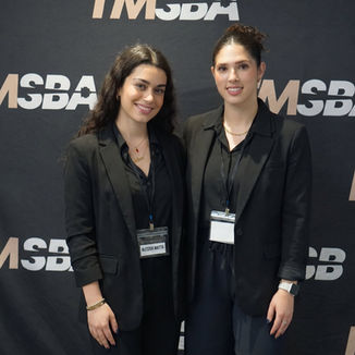 Trade show hostesses assisting attendees during a San Francisco business expo, supporting exhibitor hospitality, guest communication, and branded booth interaction at a professional industry networking event.